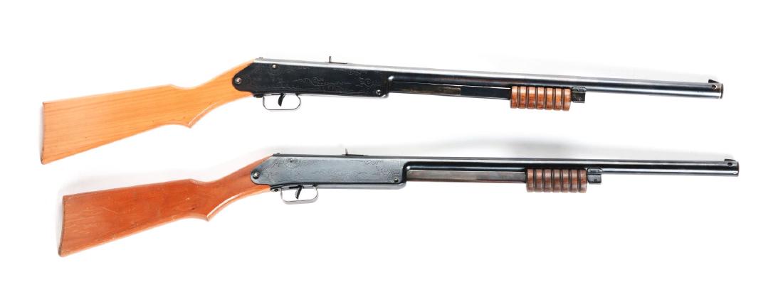 Lot of 2: Daisy Model 107 Buck Jones Special Air: Both manufactured between 1934-42. Slide action, sundial markings on wooden stock, needle or floating compass, "Daisy" marked on compass dial, 60 shot gravity fed magazine, fixed rear sight. Gun A) Re
