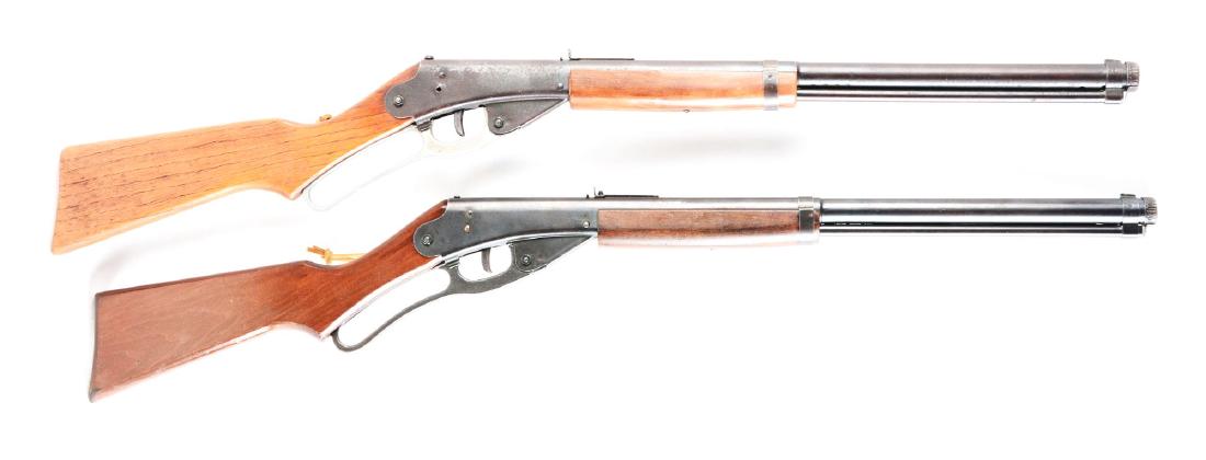 Lot of 2: Daisy No. 111 Model 40 Air Rifles.: Both are BB/.175 caliber, 1000 shot, lever action, wood stock and forearm, saddle ring with leather thong. Red Ryder brand burned into left side of stock. Gun A) Retains very little original finish. F