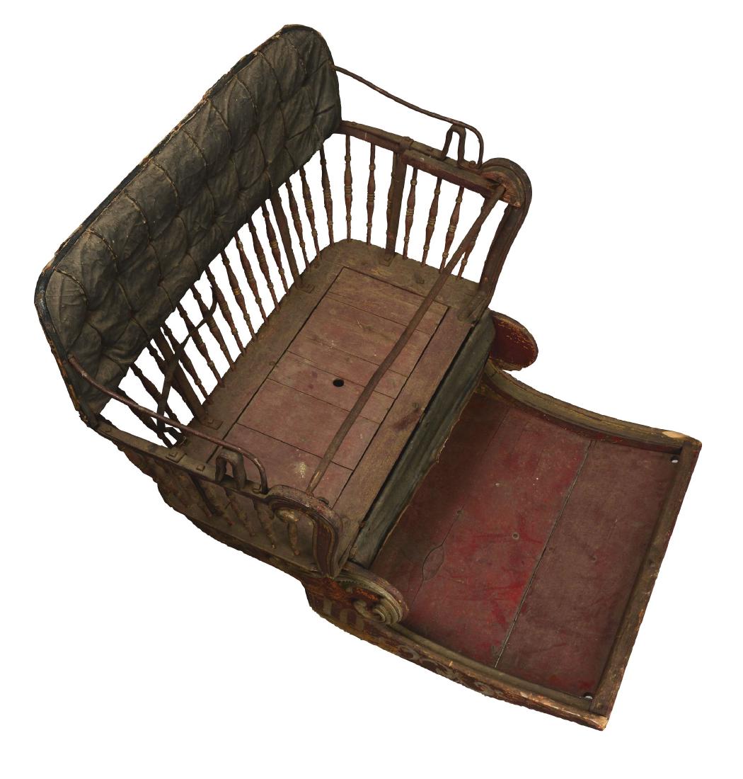 Antique World's Fair Ferris Wheel Seat.: This Ferris wheel seat is constructed of wood with an iron lap bar and black leather tufted seat back. The finish shows much wear with patina throughout. A red hue on the footrest indicates that this