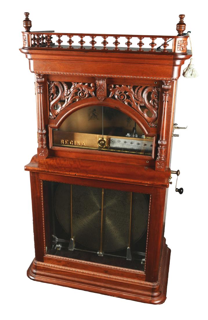 25¢ Regina 27" "Dragon Front" Automatic Disc Changer: Coin operated automatic 12 disc changing music box with a motif of carved dragons, the discs played by a duplex comb. The magnificent Regina music box is housed in a rich mahogany cabinet with excepti
