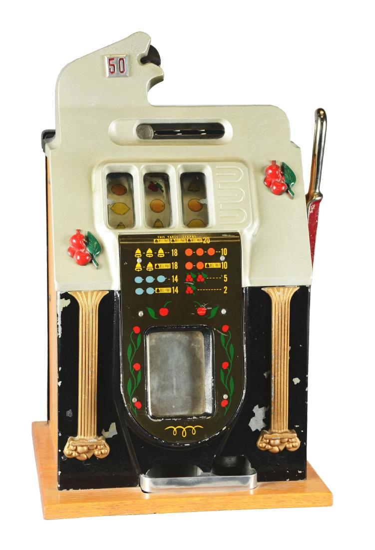 **50¢ Mills Golden Falls Slot Machine.: Three-reel slot machine with silver and black front casting featuring gold columns and red cherry clusters. Manufactured by Mills Novelty Co. from 1945-1949. The front casting shows minor paint flakin