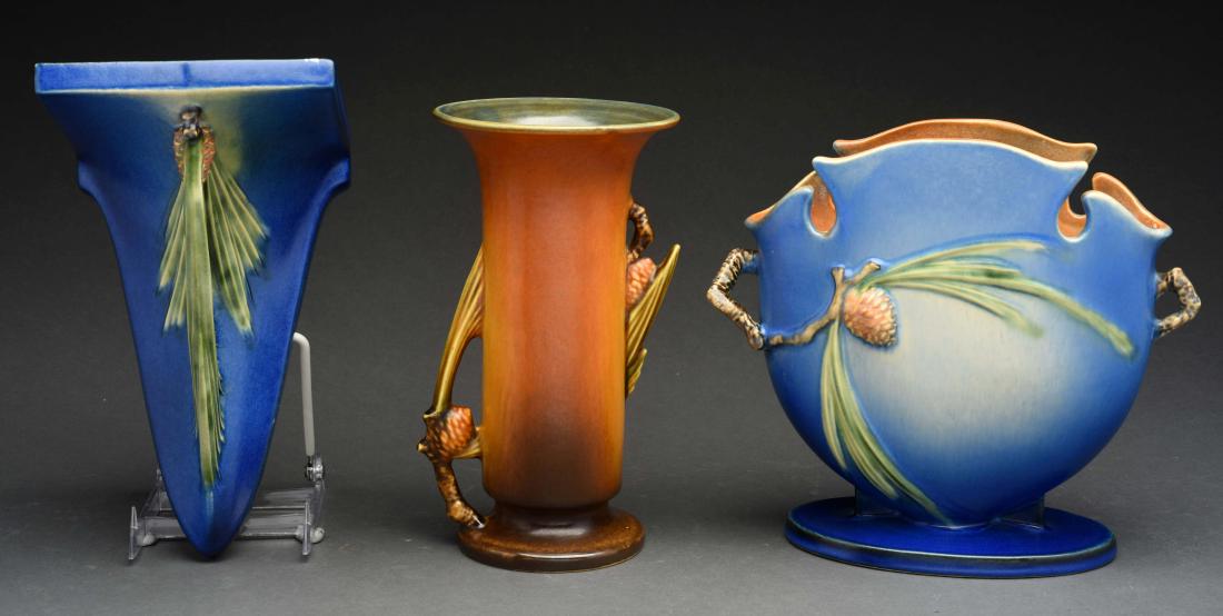 Lot Of 3: Roseville Vases.: 2 blue pinecone and 1 brown pinecone. Condition:(Excellent).Dimensions:Largest : 8 -1/2" x 4 -1/2". Condition: (Excellent). Dimensions: Largest : 8 -1/2" x 4 -1/2".