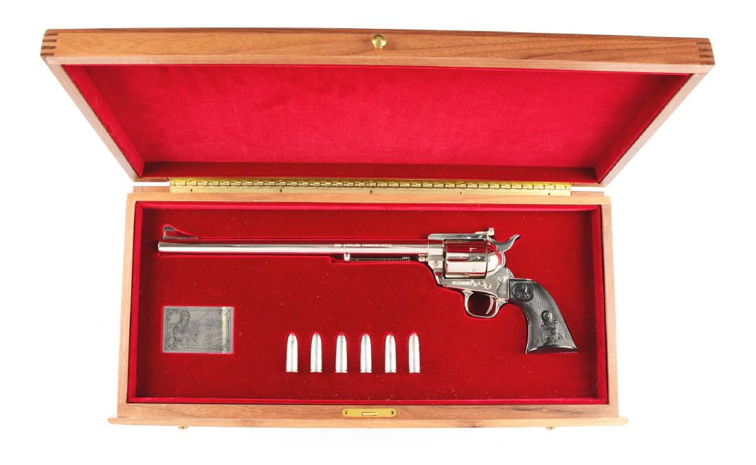 (M) Ned Buntline Colt Cmmemorative New Frontier Single: Like new in box. Features include; full round barrel with ramp front sight and Ejector housing. "NED BUNTLINE COMMEMORATIVE" on left side of barrel. Fluted six shot cylinder. Single action flat top wi