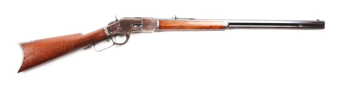 (A) Winchester Model 1873 Lever Action Rifle.: Manufactured 1883. Features an extra long full octagon barrel, full magazine, sporting sights, blued finish, walnut stock. Frame retains traces of original blue. Strong case colors on hammer. Barrel i