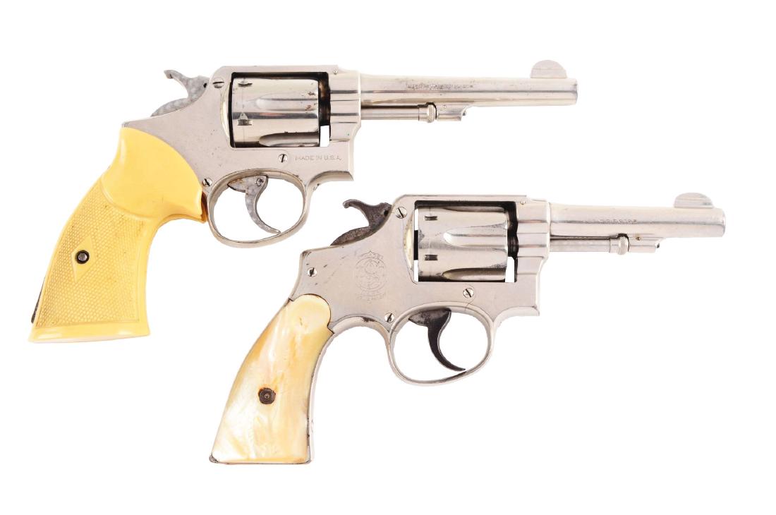 (C) Lot of 2: Smith & Wesson Double Action Revolvers.: Gun (A) is a six shot, double action M&P. Features pinned barrel and five screw square butt K frame. Retains 90% original factory nickel finish. Matching numbers on barrel and cylinder. Sports a pair