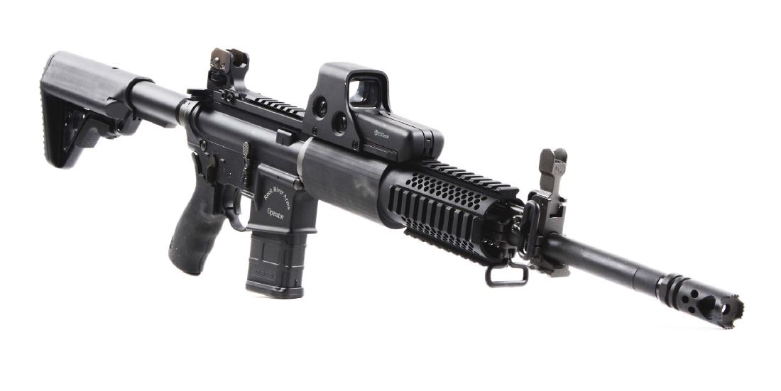 (M) Rock River Arms LAR-15LH Semi-Automatic Rifle.: Left-handed Rock River Arms Operator. Matte black finish, heavy round barrel with flash suppressor, folding front sight with rail below. Semi-automatic left-ejecting upper with aluminum free-floating 