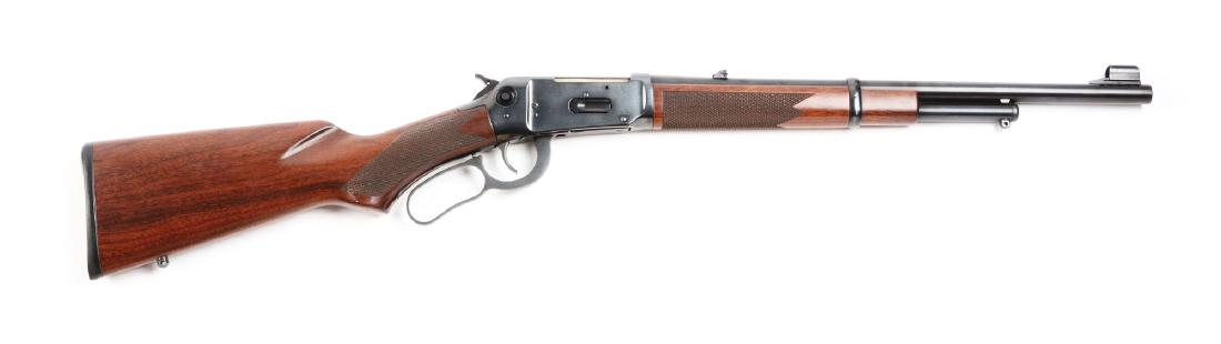 (M) Winchester Model 94AE Lever Action .444 Carbine.: Great large bore carbine with round blued barrel, frame, and partial tube magazine. Hooded front sight and flip-up adjustable rear sight. Features a hammer safety and checkered walnut stocks. Appears 