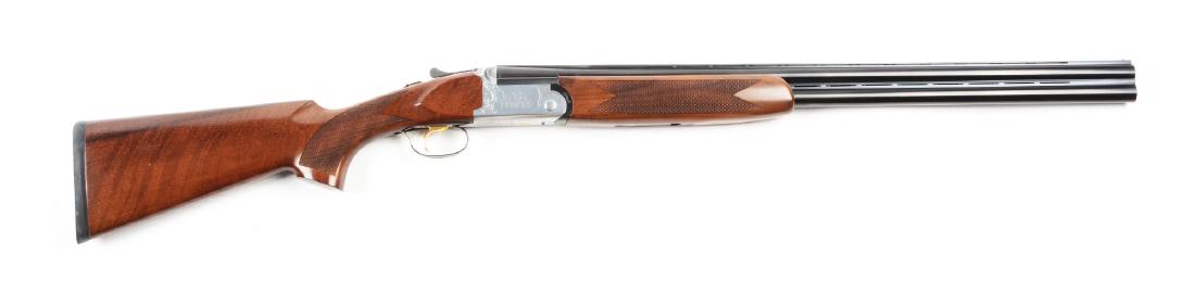 (M) National Wild Turkey Foundation Over/Under Shotgun: Round blued barrels separated by vented rib and with vented matte rib and single brass bead on top. Stainless steel scalloped boxlock action with engraved scrolls, turkeys, and "NWTF" on both sides an