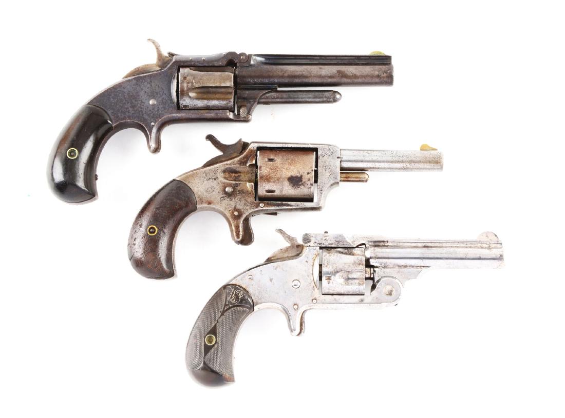 (A) Lot of 3: Antique Spur Trigger Revolvers.: Gun (A) is a Smith & Wesson No. 1 - 1/2 that features blued finish, round ribbed barrel, tip-up frame, five shot, single action, spur trigger, walnut bird's head grips, and case colored hammer. Gun re