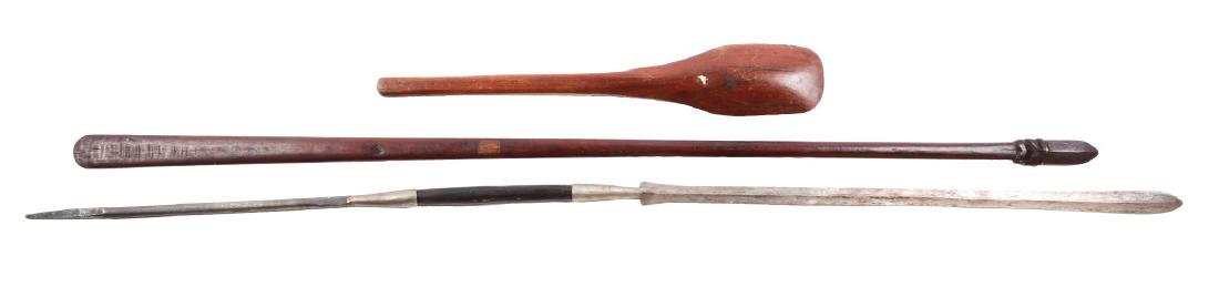 Lot of 3: African Weapons.: Comprising an wooden war club measuring about 25", with a bulbous head, a wooden ceremonial spear measuring 57" overall, and a double headed spear of of 64" overall with a spike at one end and a blade