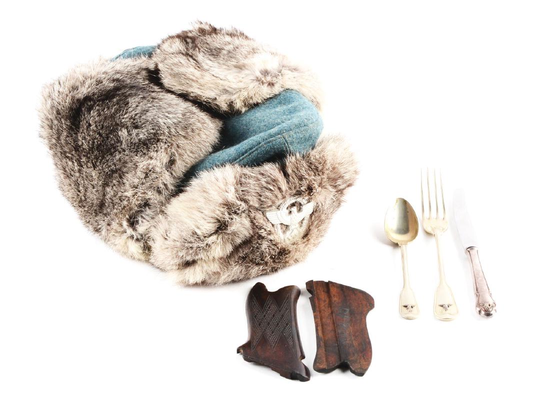 Lot of German World War II Winter Cap, Luger Grips, a&: Lot contains a German World War II Police winter cap (A), a pair of custom Luger grips (B), and three pieces of mess hall silverware (C). (A) A rabbit fur Police winter cap with Nazi Police aluminum e