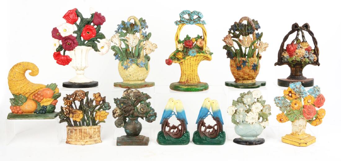 Lot of 11: Cast Iron Contemporary Doorstops & Bookends.: Ten doorstops and one pair of bookends. Includes Poppies, Tulips, Cornucopia and others. Condition: (Good). Dimensions: Largest: 10 - 1/2" x 7 - 1/2".