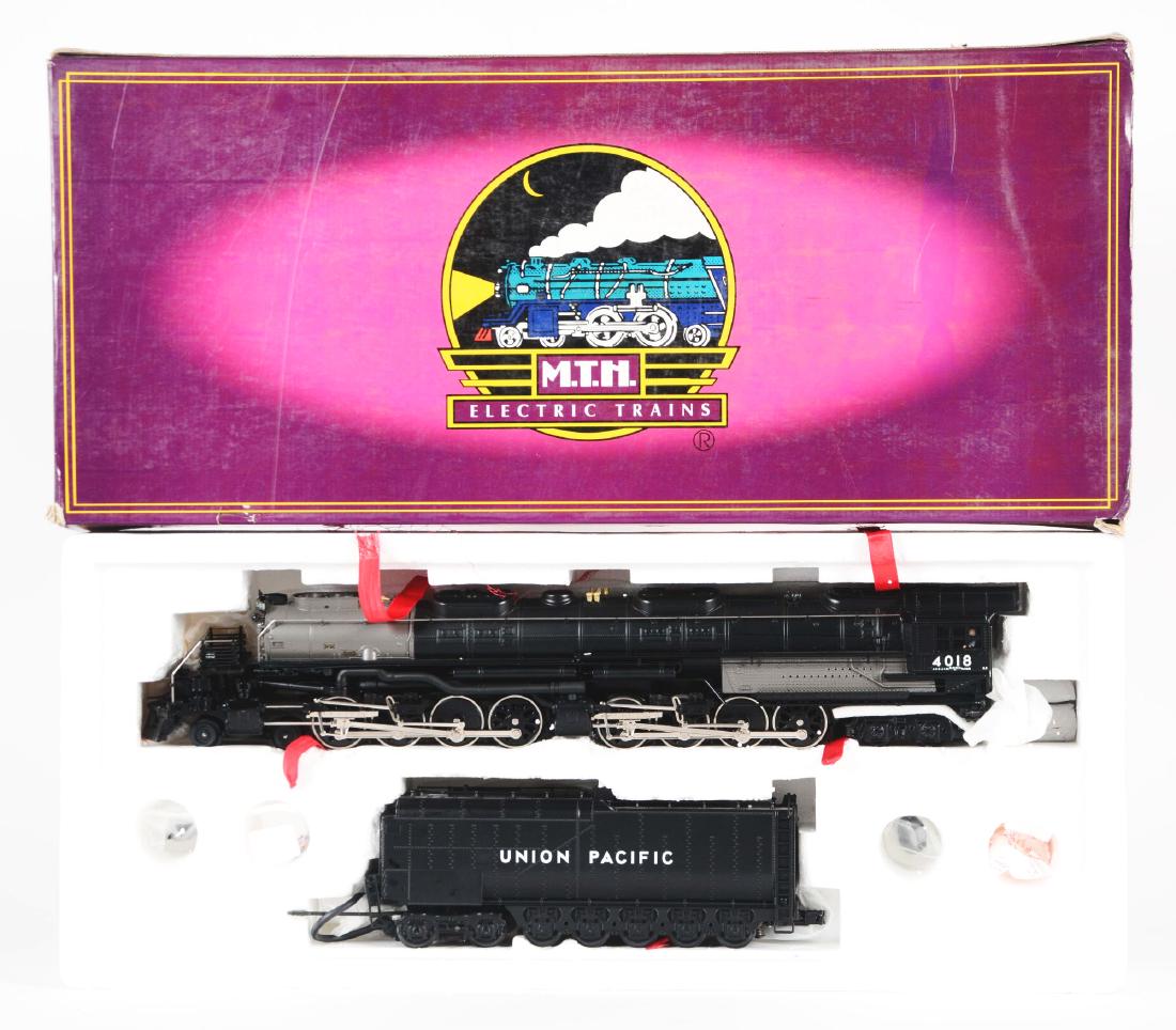 MTH Big Boy Steam Engine In Box.: O Gauge, Union Pacific Big Boy steam locomotive, with Protosounds. New in the original box. Item number is MT-3021 LP. From the Ray Bentley Collection. Condition: (Mint). Dimensions: Box: 27 - 1/2" x
