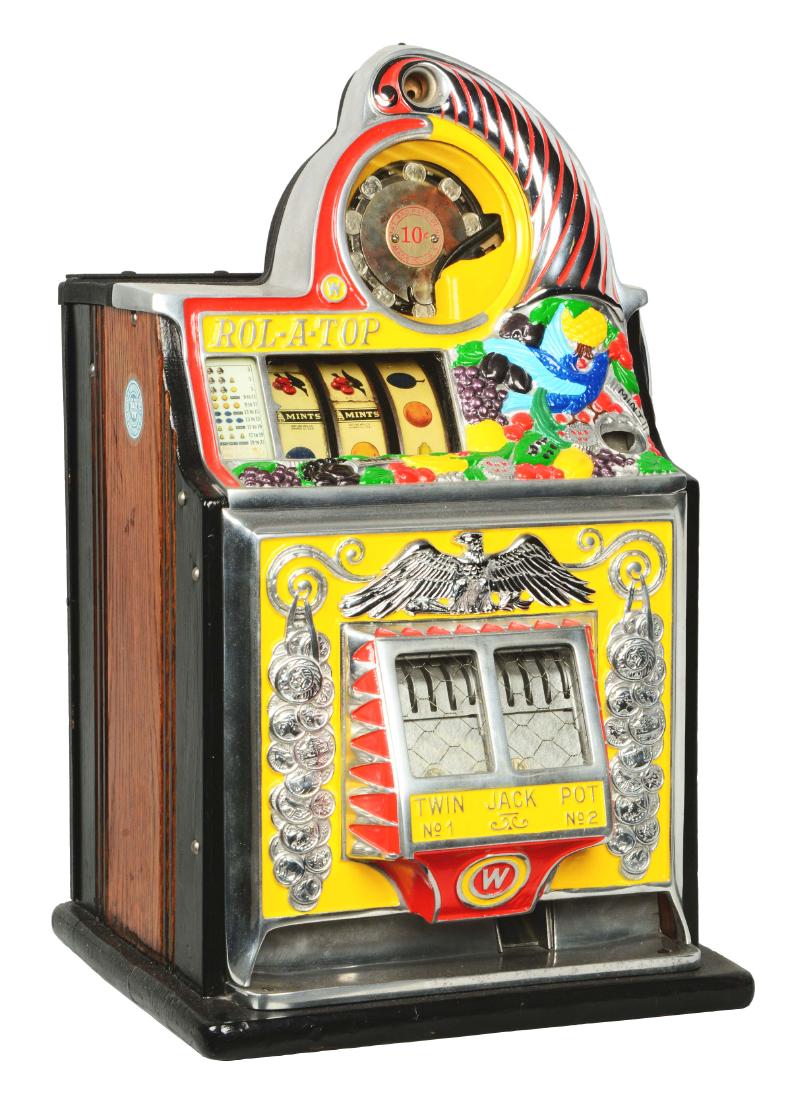 **10¢ Watling Rol-A-Top "Bird Of Paradise" Slot: This eye-catching three-reel twin jackpot machine features a highly restored, vividly colored front casting, showcasing an upturned cornucopia spilling out fruits and birds. Retaining the original tin