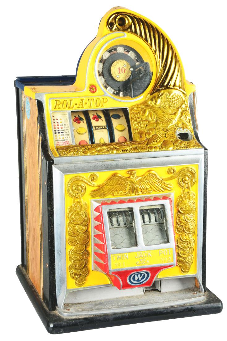 **10¢ Watling Rol-A-Top "Bird Of Paradise" Slot: This slot machine is yellow in color and features an upturned cornucopia spilling golden fruits and birds over the top and front of the machine. With twin jackpot banks proudly displayed front and cen