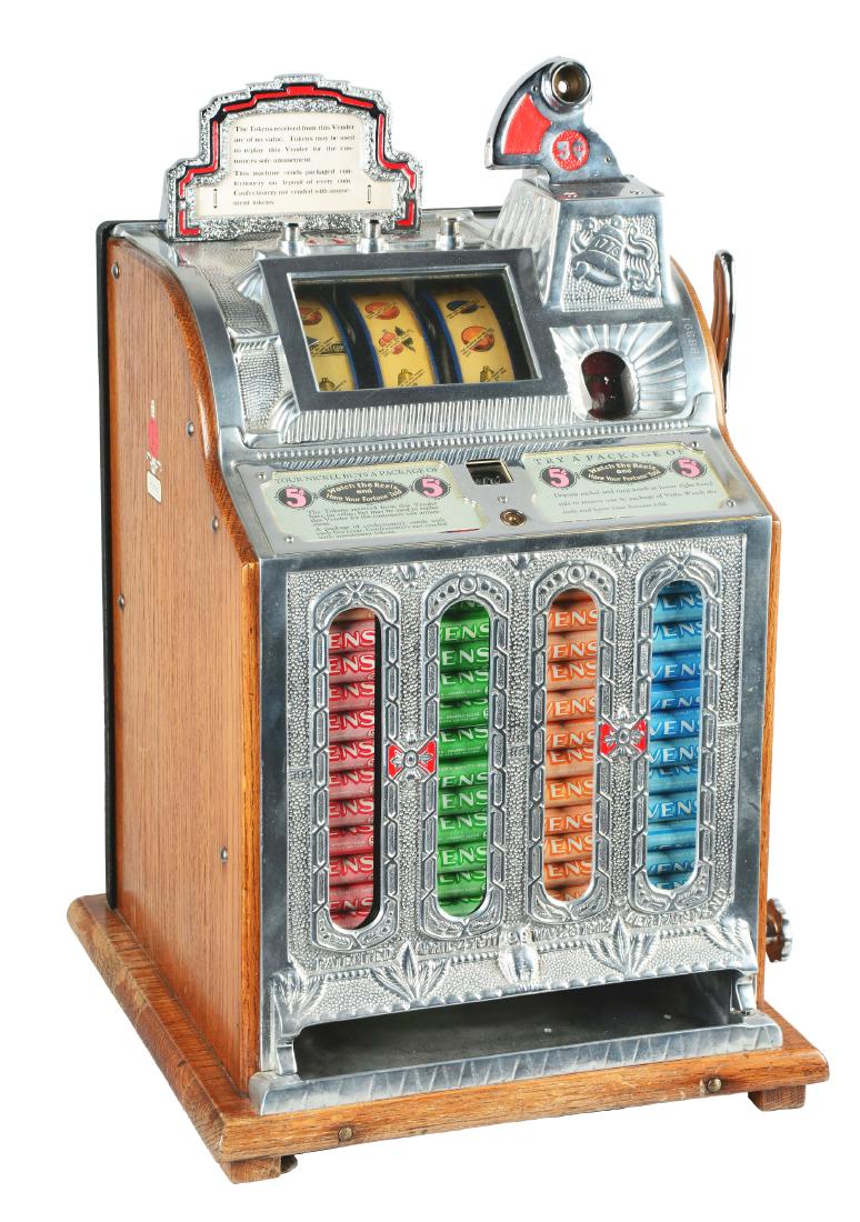 **5¢ Mills Front OK Mint Vender Slot Machine.: This slot machine was manufactured by Mills in 1925. It has a polished aluminum front casting with ornate decoration and beautifully repainted with details of red. There are 4 mint columns, the machin