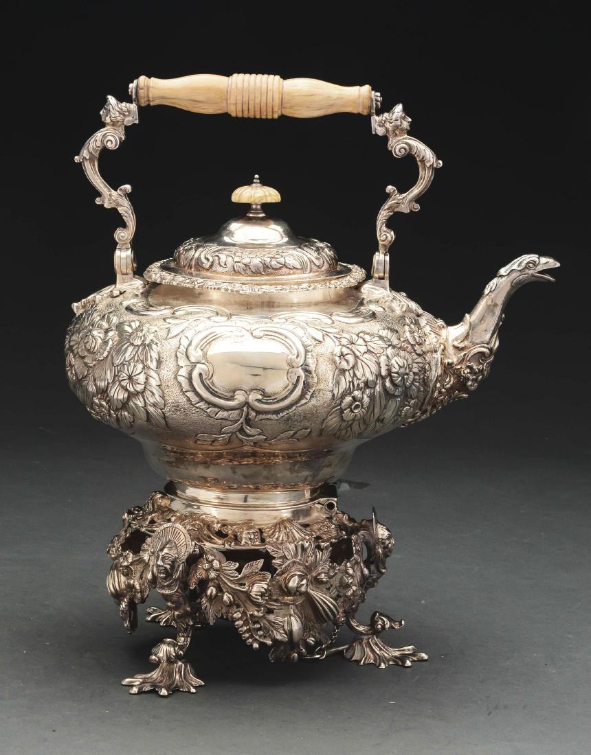 English Silver Kettle on Stand.: Joseph Pitts, London 1798, the compressed circular body on a cast and chased stand with floral and fruit festoons and three scroll legs with shell-form feet. The body later-chased with groups of broad