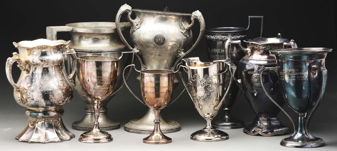Nine Silver Plated & Pewter Trophies.: Most two-handled with urn-form bodies, including one silver plate example commemorating the First Annual Century Run of the Crescent Wheelmen, 1898, with a flared foot; another for the Southern Pines 