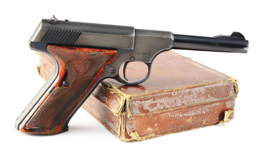 (C) Boxed Colt Woodsman 2nd Series Sports Model: The Second Series Sports Model was manufactured from 1947 to 1955. Features blued finish, wind drift rear sight, brown composite plastic grips with logo and no thumb rest, and Colt marked magazine. Pi