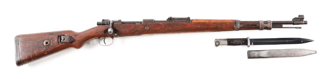 (C) WWII German byf 44 98K Mauser Rifle With Bayonet.: Gun retains an even age patina overall showing wear. Import marked on the barrel. Numbers are not matching. byf 44 code for Mauser 1944. Good mechanical function. Stock shows wear with dings and handl