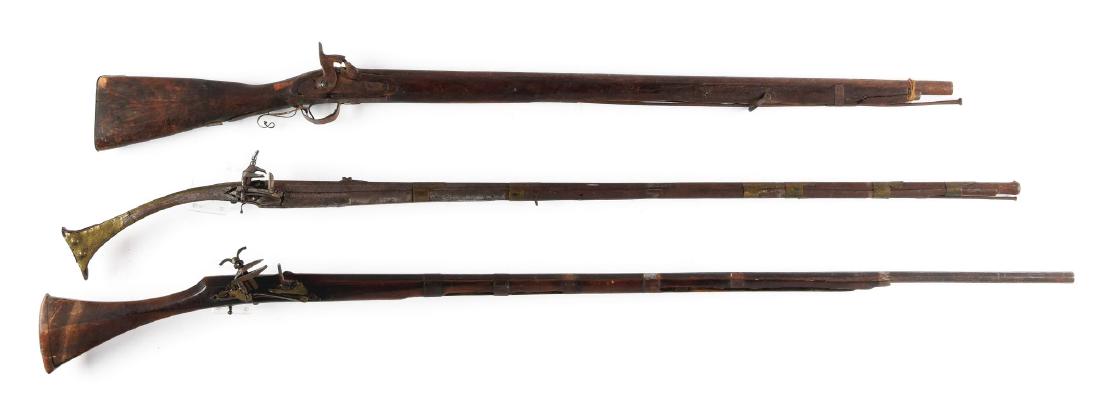 (A) Lot of 3: Middle Eastern Miquelets and Percussion: Comprising: A) An Albanian miquelet rifle with cannon muzzle. Engraved steel stock of familiar form. Fair condition showing some use overall. B) Moroccan miquelet musket in fair to poor condition, som