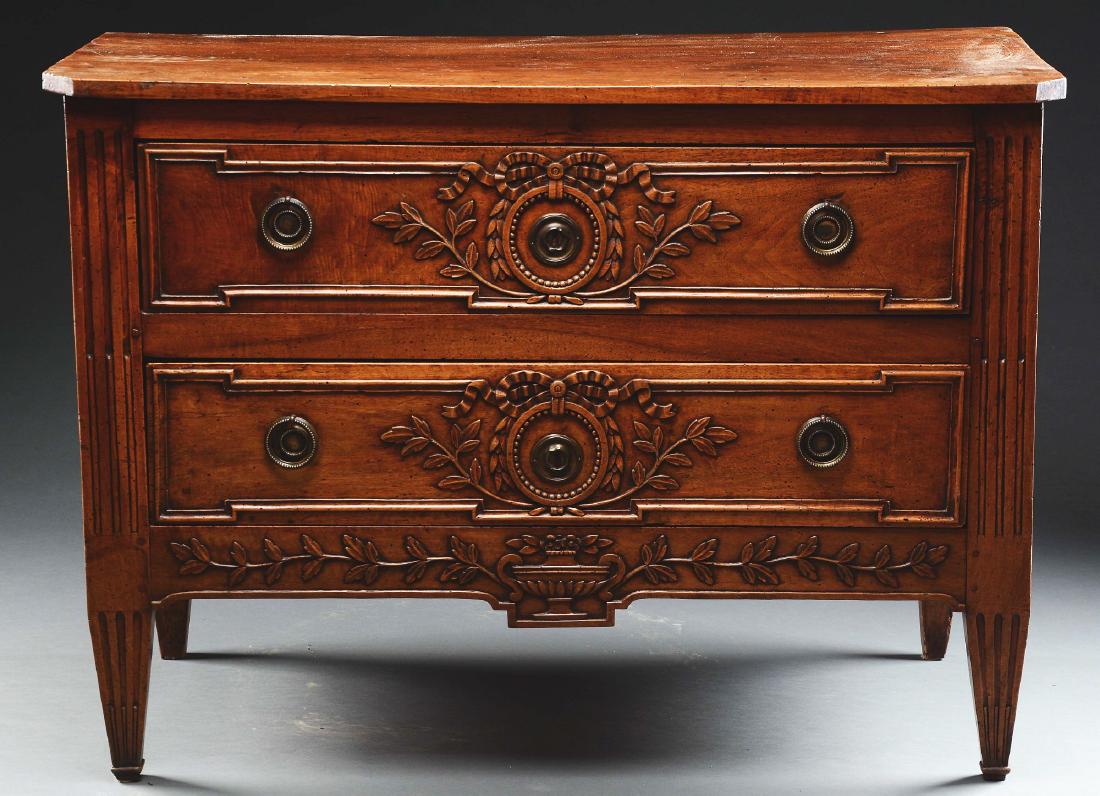 Louis XVI Style Carved Fruitwood Commode.: Late 18th century, France. The rectangular top with canted corners above the conforming case of two long drawers. each carved with bow-tied foliet swags and leafy branches centering around escheon wit