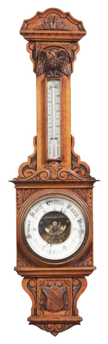 Ornately Carved Oak Aneroid Barometer with Eagle Form.: Late 19th Century, American. This very nice example with arched cresting above a cornice continuing to the carved throat fitted with a encased thermometer with Fahrenheit and Centigrade scales above w