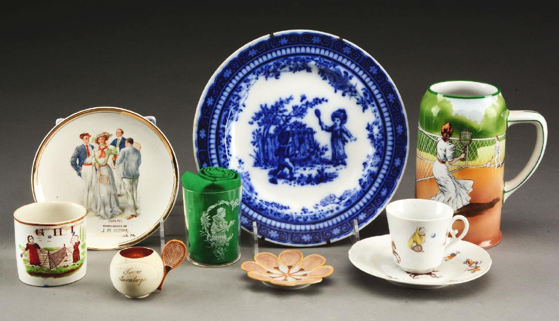 Lot of 9: Tennis Themed Plates & Mugs.: 19th to 20th century. The collection includes an early ABC mug, transfer ware glass, a tea cup and saucer. There is a large 1910's era stein marked "Austria" and a small match holder. Plates include a