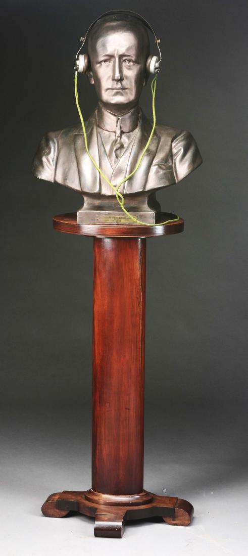Lot Of 2: Papier Mache Bust of Marconi.: Life size paper mache bust, marked "His Excellency the Marquis Marconi" with the initials G.C.V. O. at the bottom of the tag. The bust sits on a wooden pedestal base, 36” tall. Also included is a pa