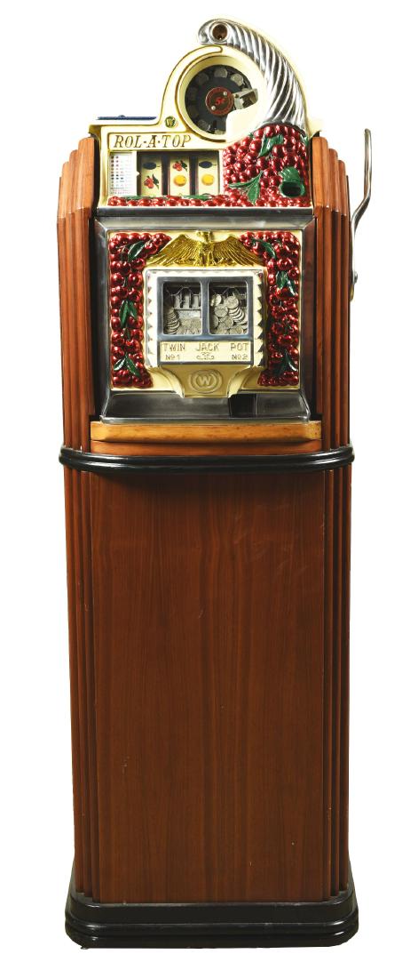 **5¢ Watling Rol-A-Top Cherry Front Twin Jackpot: There are many variations of the Rol-A-Top slot machine, this is the Cherry Front Twin Jackpot floor model slot machine with wooden console, manufactured by Watling in 1938. It has a cast aluminum fro