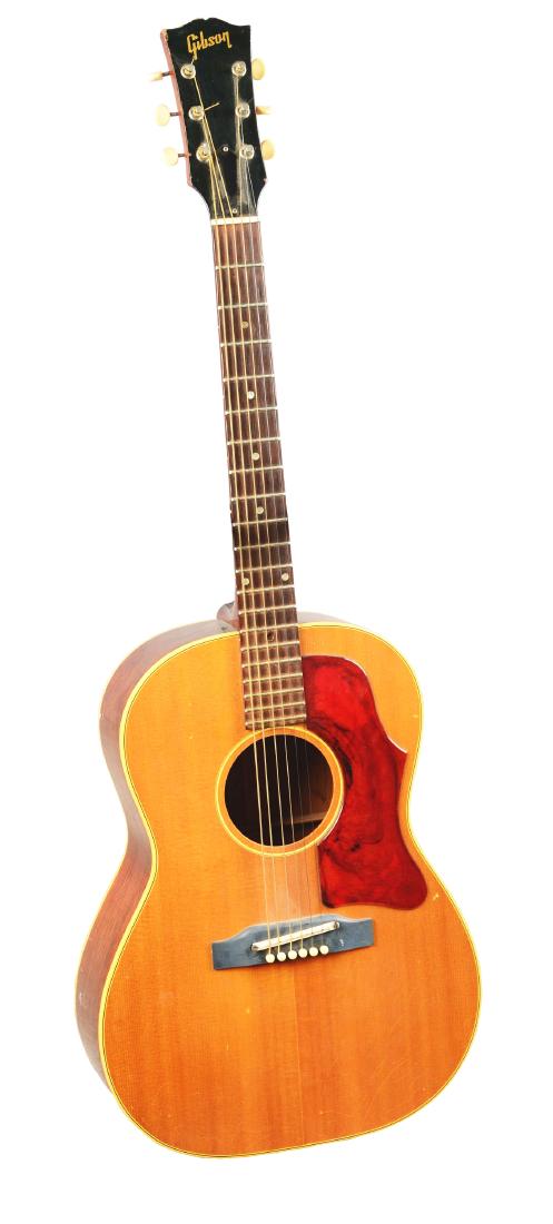 Gibson B-25 Acoustic Guitar.: 6-String acoustic guitar produced by Gibson during the mid-1970s. This hollow-body arch top guitar features a natural finish and red plastic pickguard. Serial number 303159. Some age and use related w