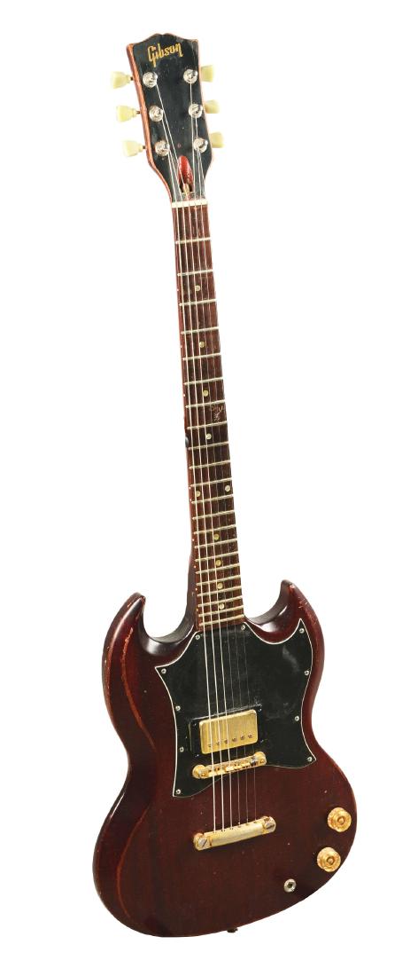 Gibson SG Junior Electric Guitar.: Wine colored body with double cutaway design and golden hardware. The finish shows crazing and wear throughout the body, neck and back of the guitar. Missing rear panel. Marked with serial number 0027