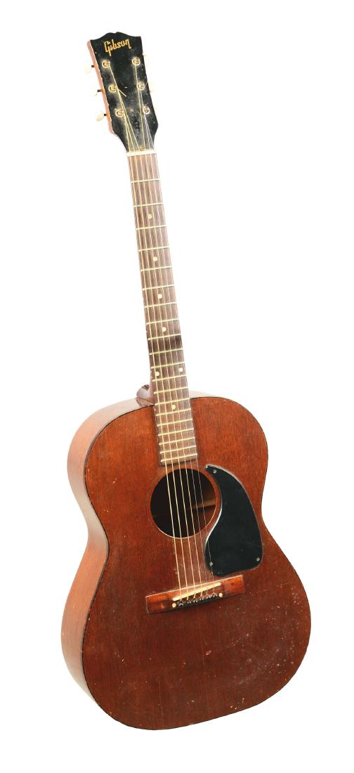 Gibson LG-0 Acoustic Guitar.: A simple acoustic guitar manufactured by Gibson, ideal for a fresh musician. The guitar is made of mahogany, showcasing its natural mahogany finish and has dotted pearl inlay on the fretboard. Feature