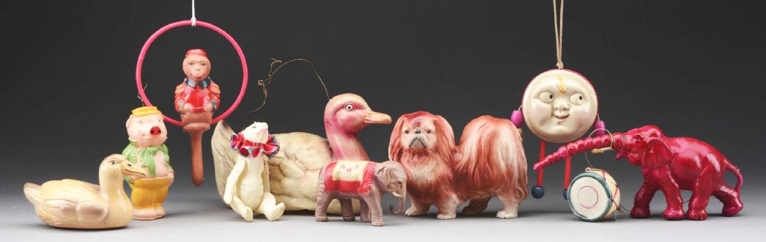 Lot of 10: Celluloid Christmas Ornaments.: Lot includes two ducks, two elephants, a moon rattle, a monkey on a ring, a pig, a dog, a drum and a jointed polar bear. All hung on Dolph’s Christmas trees.Condition: (Very Good - Excellent).Dimens