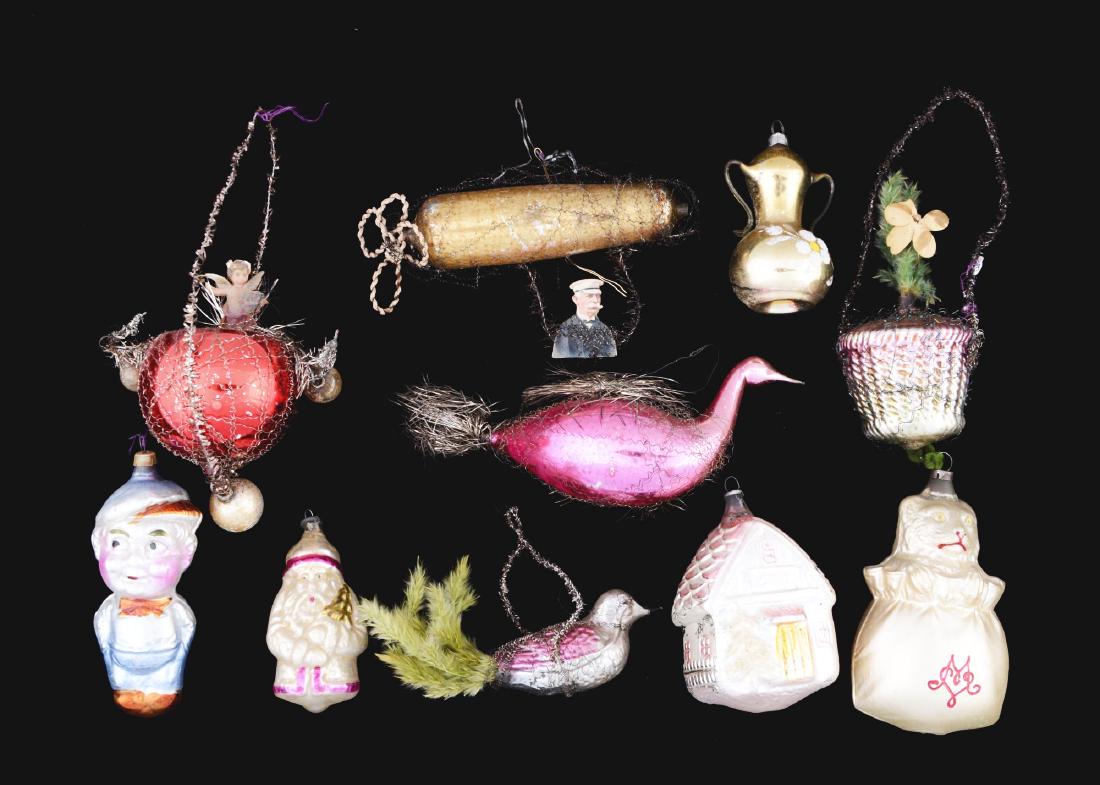 Lot of 10: Glass Christmas Ornaments.: Lot includes a large cat in the bag, a Smitty, a zeppelin with Count Zeppelin scrap hanging from the bottom, a Santa house and various others.Condition: (Excellent).Dimensions: Largest: 6" x 2 -1/2".