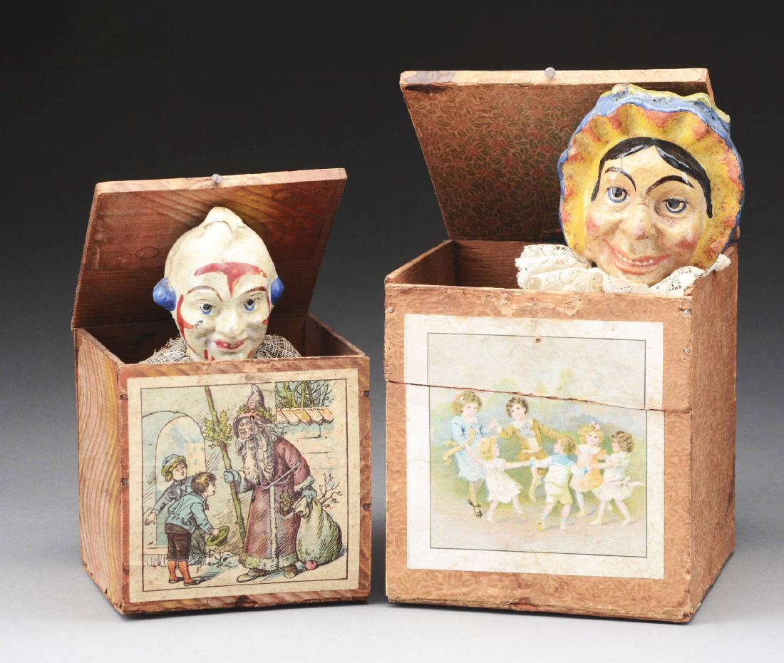 Lot Of 2: Jack-In-The-Boxes.: The larger Jack-in-the-Box or surprise box, the British term, features a Judy-like character, the other is a clown Jack-in-the-Box with Santa pictured on the front. Wood boxes are covered with front l