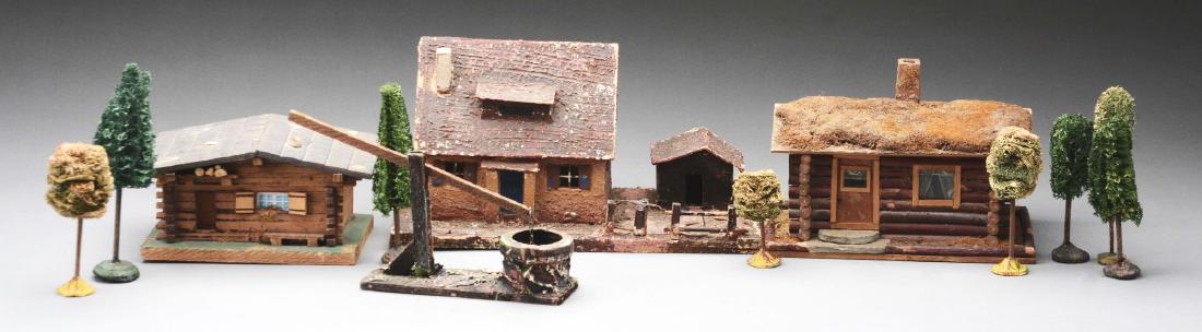 Lot Of 12: Three Village Houses, Well, & Eight Trees.: Tallest house is 7-1/2" tall. The log house has a roof that flips up and could be used as a box. Eight sphagnum moss trees.Condition: Dimensions: Largest: 12" x 6 - 1/4".