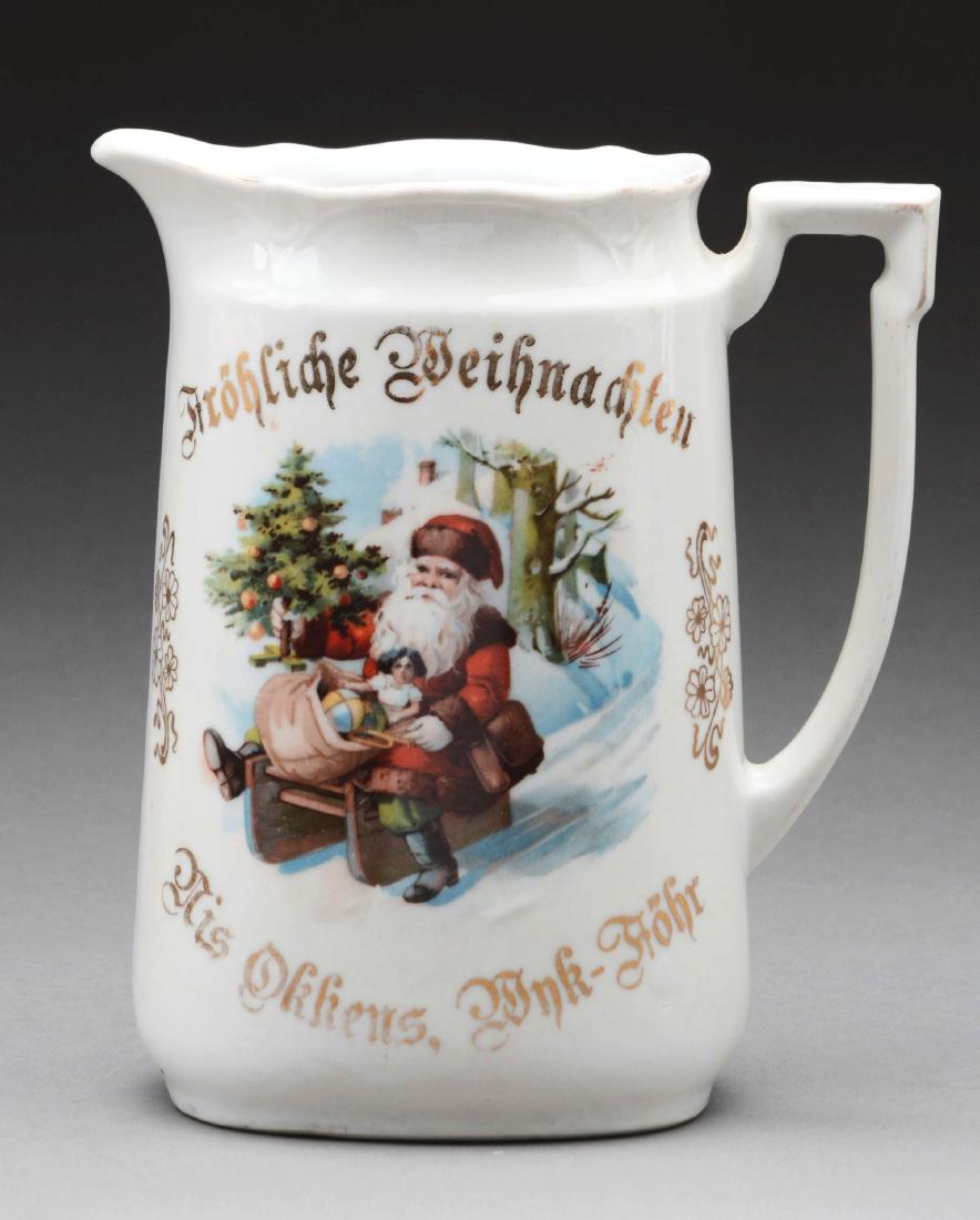German Pitcher.: Pitcher depicts Santa sledding marked "Merry Christmas" on top in German and other phrases across the front.Condition: (Excellent).Dimensions: 6 - 1/4" x 5 - 1/2".