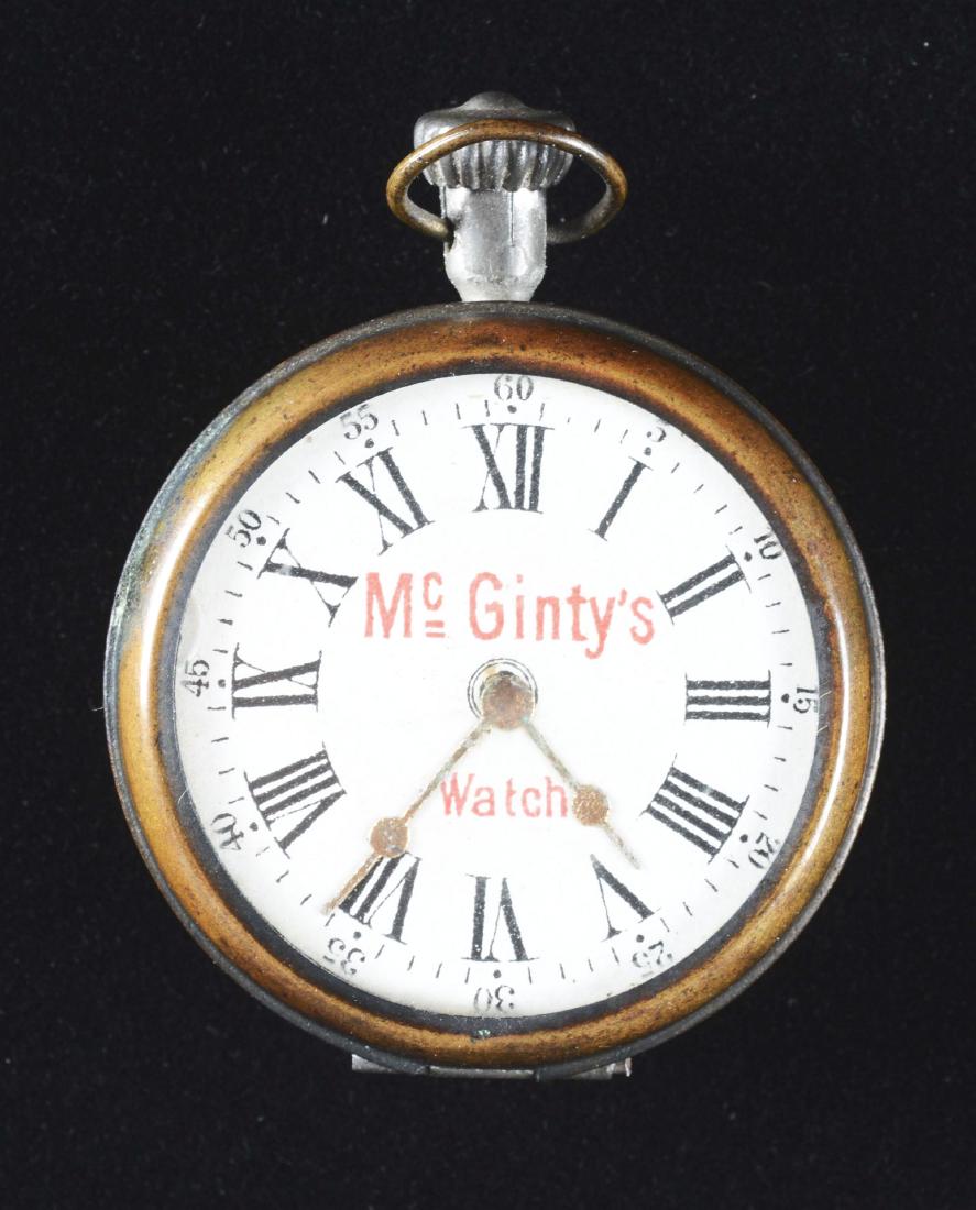 McGinty's Pocket Watch In Box.: This wonderful surprise piece emits a devil like image when the watch is opened. Made as a Halloween novelty toy, a rare find.Condition: (Very Good).Dimensions: 2 -1/2" x 2 -1/2".