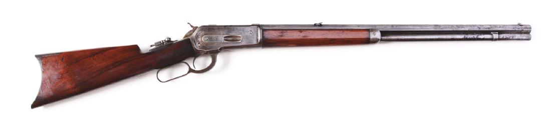 (A) Winchester Model 1886 Lever Action Rifle (1888).: Offered is a fairly standard rifle that features full octagon barrel, full magazine, sporting front sight, Winchester two leaf folding rear sight, tang sight, case colored frame, hammer and lever; wal