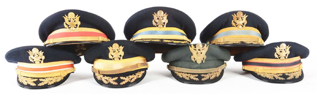Lot of 7: US Army Officer's Field Grade Dress Visor: Lot contians: A) Service dress green cap, made by Bancroft. Interior label inked "Lieut. Col. Charles M. Hoover". B) Corp of Engineers dress cap made by Gerber, Mishawaka, Ind. C) Artillery dress cap