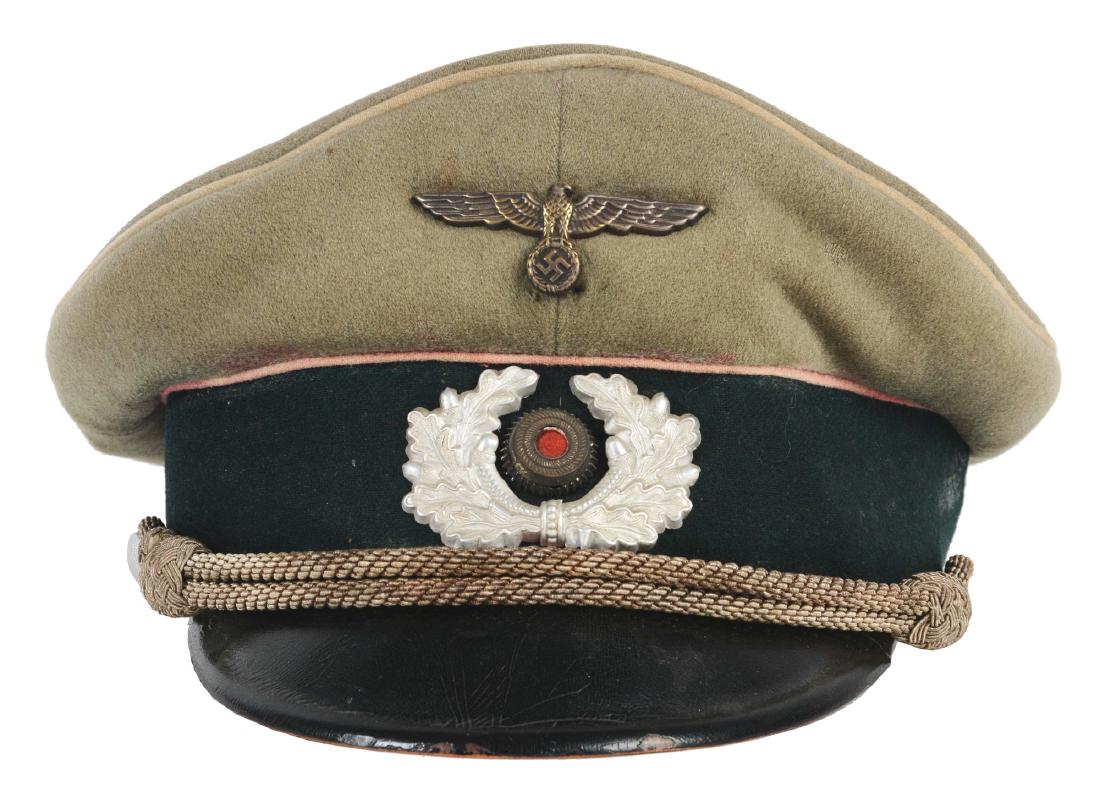 German WWII Heer Infantry Officer Visor.: Heer Infantry Officer visor cap in overall very good condition. An early war white piped visor in a field gray wool, which has been made to appear to be pink piped Panzer version. Someone has used a p