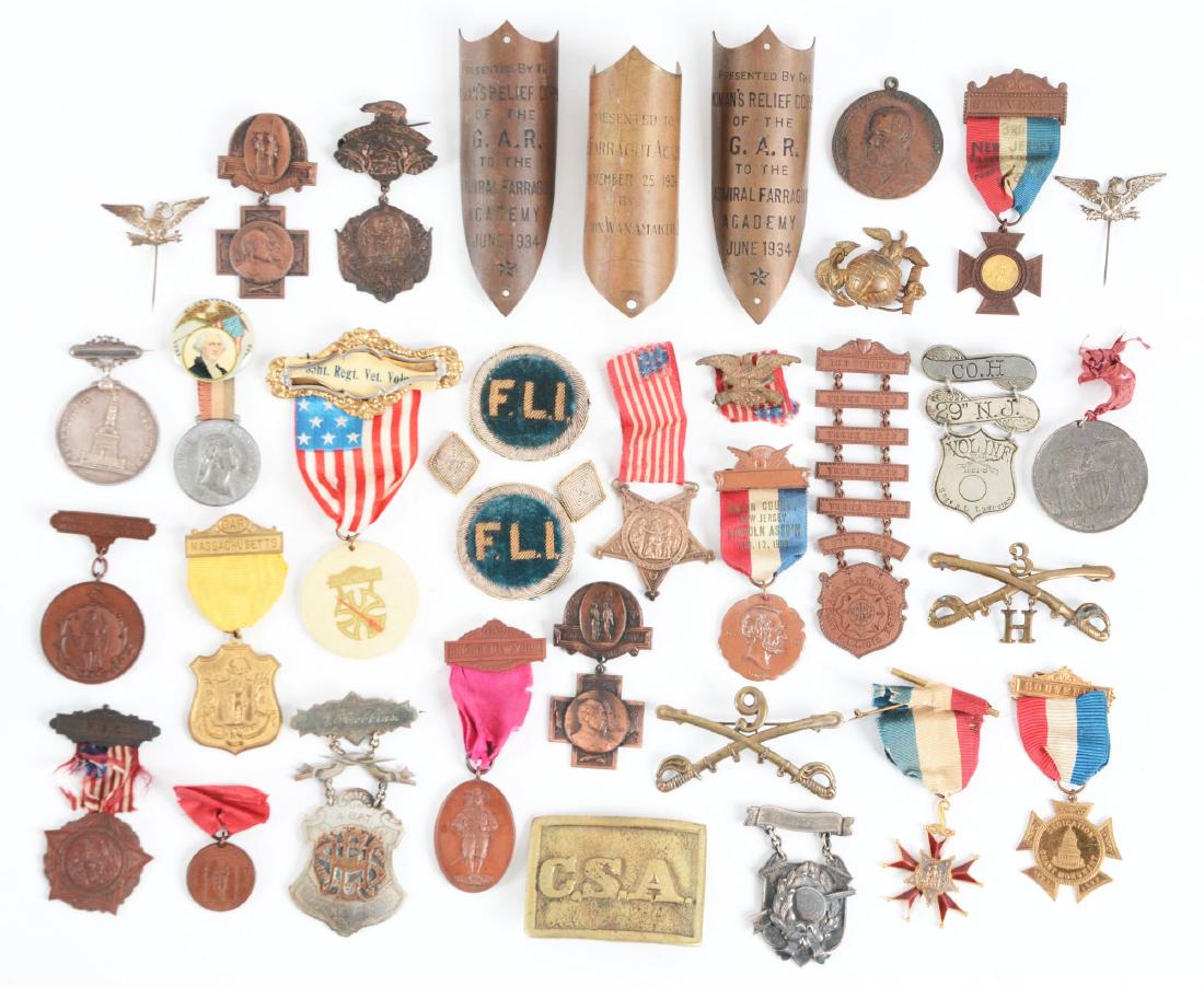 Large Lot Of G.A.R. Medals, Pins & Buckles.: Lot contains: (A) Massachusetts Minute Men 1861 medal, edge impressed "Robert Clifford, Sgt 41st Regt": "Co. H 29th N.J. Vol Inf" veterans badge named to "Segt R.L. Lawrence". (B) Two New York at Gett