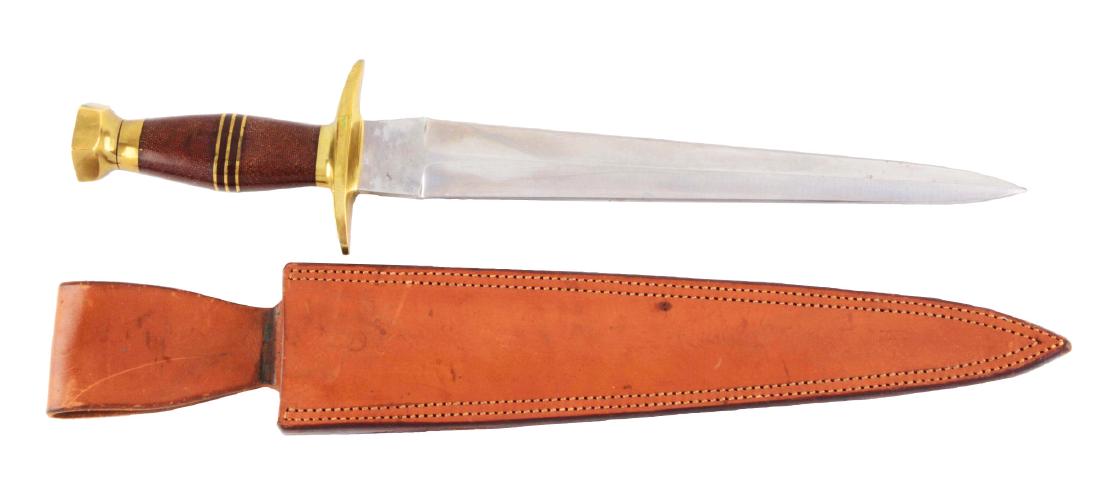 J.N. Cooper Fighting Knife.: Double edge Arkansas toothpick tapered blade. Handled in sectioned micarta with heavy brass C-guard and brass pommel. Correct sheath. This is the very knife that was used in the movie "The Sacketts" s
