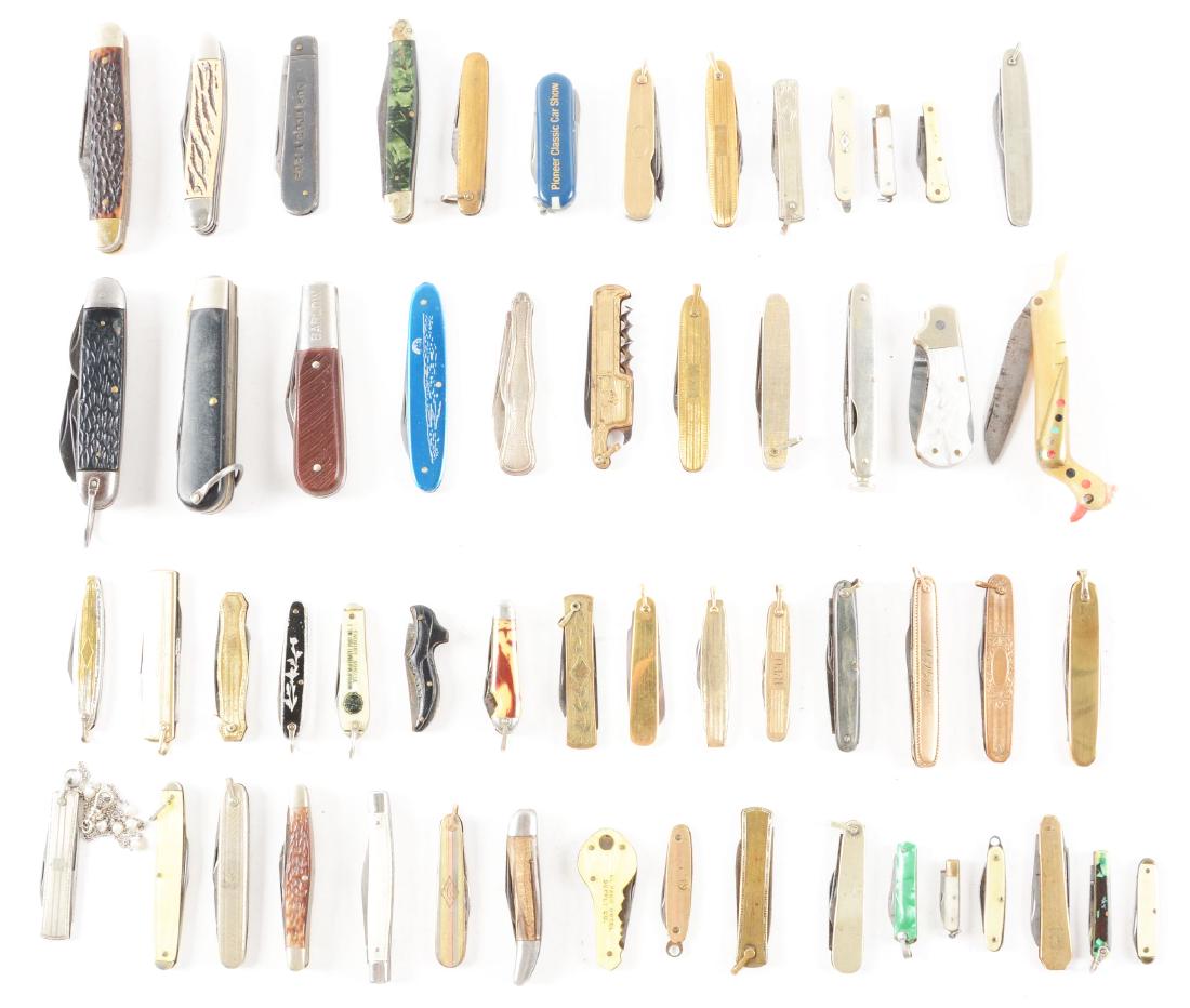 Lot of 56: Folding Pocket Knives.: Lot contains: 56 folding pocket knives, the largest of which is a 3-7/8" 3 blade Stockman made by Cutmaster. Most of the knives consist of keychain and fob knives. Most fob knives are plated. One fob 