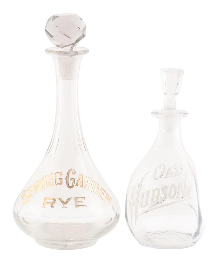 Lot of 2: Old Hudson & Spring Garden Rye Back Bar: The Old Hudson bottle with a painted on logo on the front. It has some chips on the bottom of the stopper. The Spring Garden Rye bottle has a ground stopper with no chips. Both bottles display well an