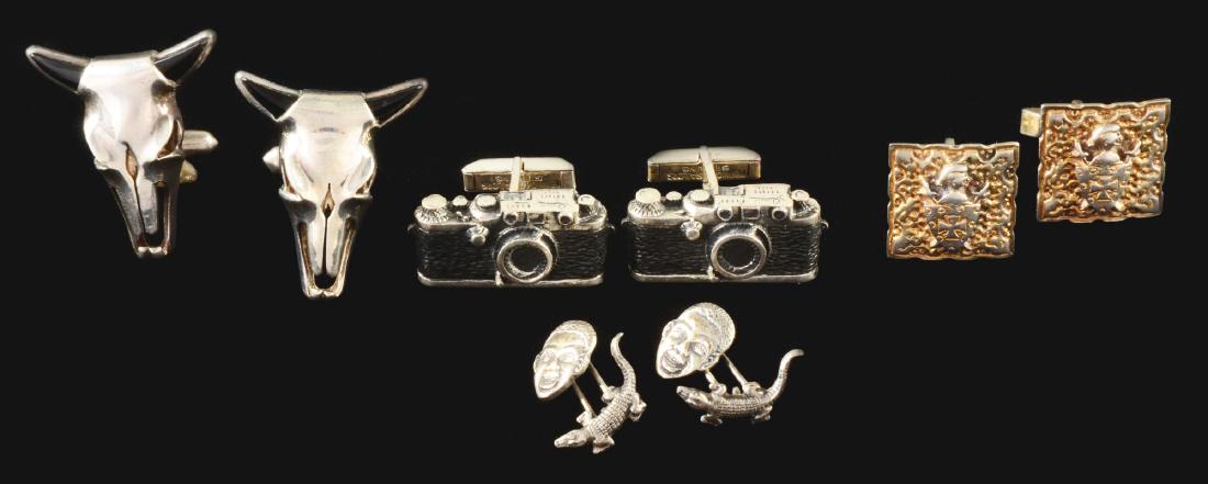 Lot of 4: Sets Of Cuff Links.: Lot includes: a Foster and Sailor embossed shields; an Antonio Taxco, onyx and silver cattle heads, 1-1/2" long; a pair of sterling camera cuff links, 1" wide; and a pair of sterling silver alligator 