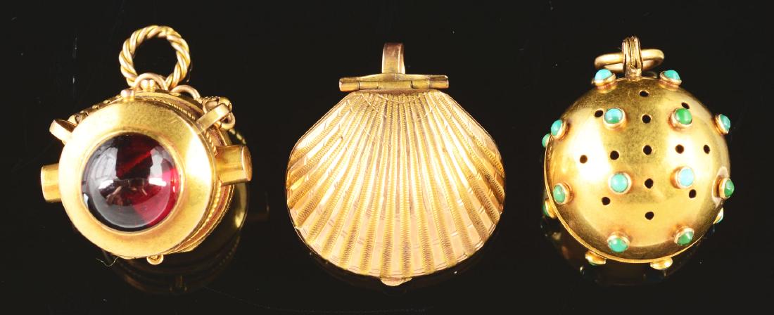 Lot Of 3: 14K Yellow Gold Vinaigrettes.: Lot includes: a 14K yellow gold bomb shaped vinaigrette with turquoise studs and registering mark; a 14K yellow gold locket vinaigrette shaped as a port hole with a red stone on the vinaigrette side a