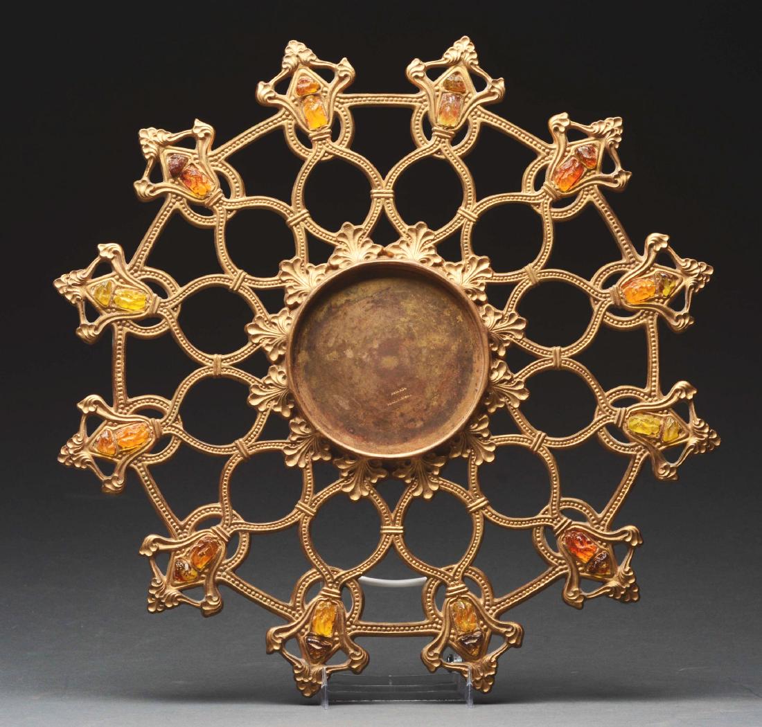 Tiffany Studios Centerpiece.: Tiffany Studios cast bronze centerpiece has center vase ring surrounded by stylized fleur de lis. Open rings lead to an outer border of stylized fleur de lis. Each set with an amber glass chunk jewel.