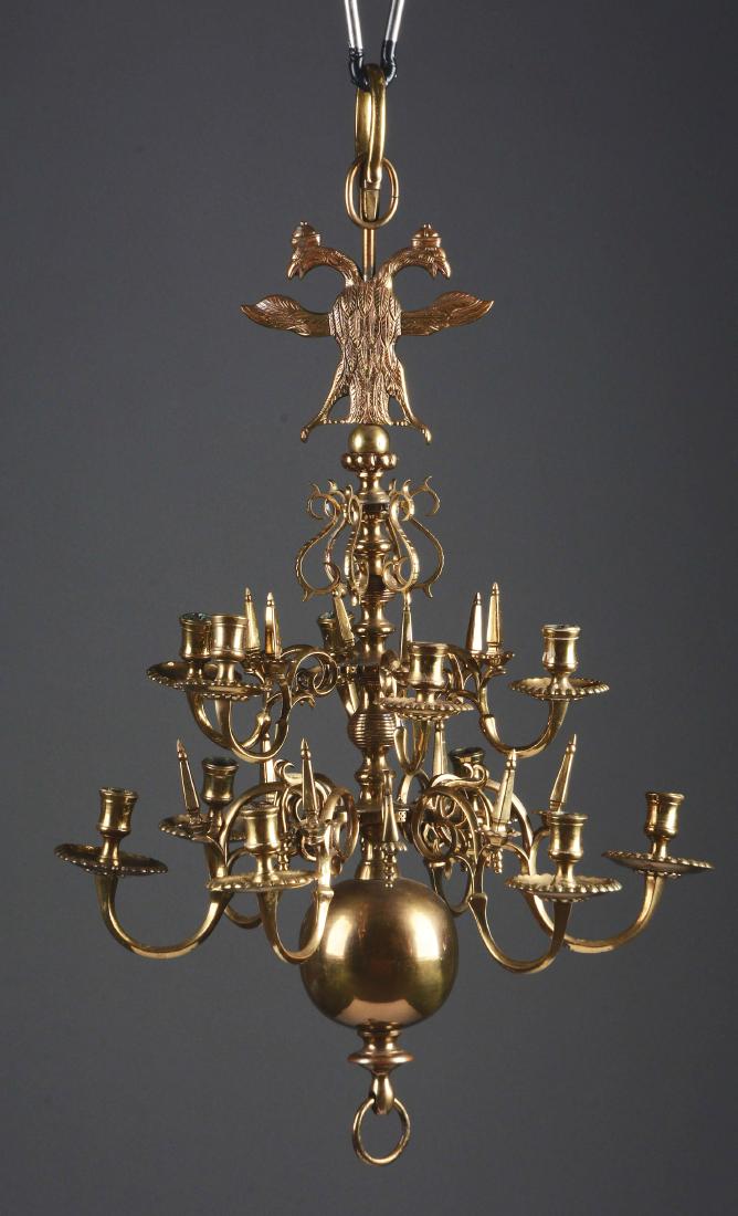 Good Dutch Baroque Style 12 Light Brass Chandelier.: Late 18th to 19th century, Holland. The baluster form shaft with large ball finial and Prussian eagle crests issuing two tiers of six scrolled arms, alternating with small decorative arms, each number